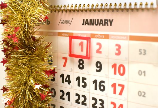 Sheet of a calendar for January, 2010 decorated with a tinsel.