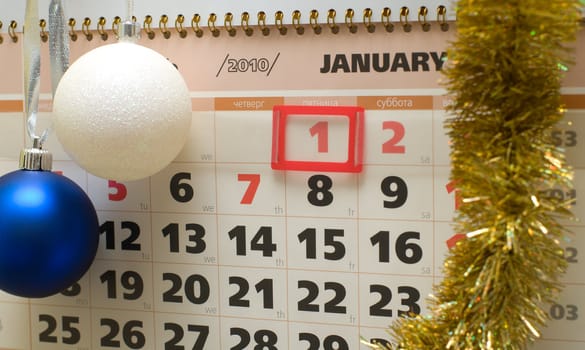 Page of a calendar for January with New Year's spheres and a tinsel.