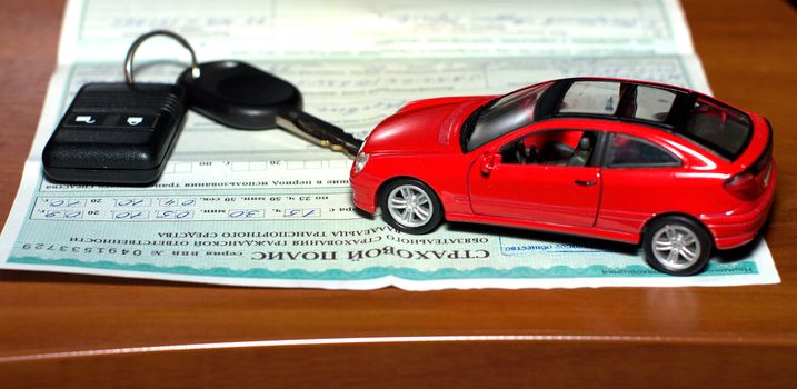 Insurance policy, the toy car and car keys.