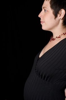 profile portrait of a late twenty pregnant women 