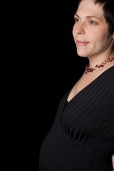 profile portrait of a late twenty pregnant women with head turn toward the camera