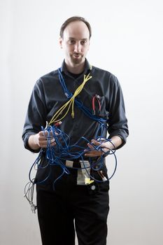 Computer technician looking exaperated holding network cable