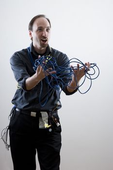 Computer technician looking exaperated showing network cable