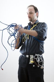 Computer technician looking confuse trying to untie network cable