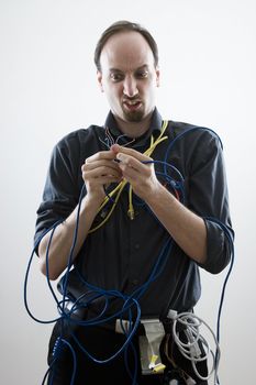 Dumb technician lost by wires in his hand