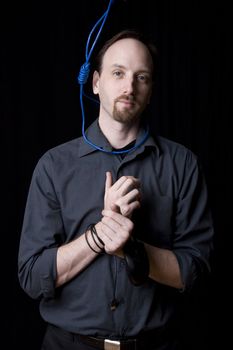 Computer technician with tied hands and hangman noeuce around his neck