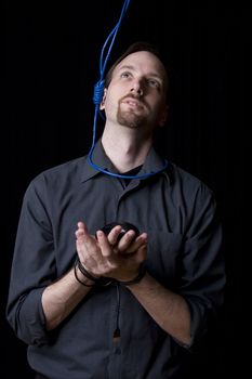 Computer technician with tied hands and hangman noeuce around his neck looking up