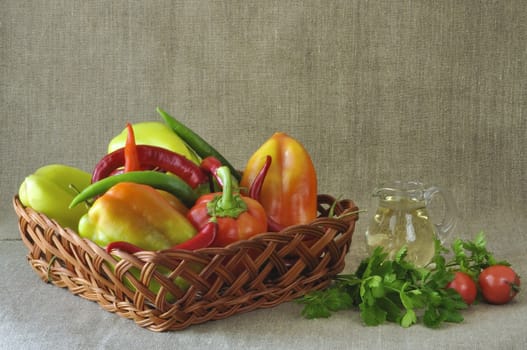 Vegetables in a wattled basket and a vegetable oil decanter
