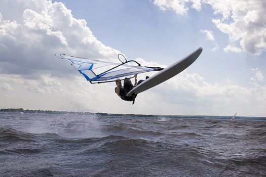 Windsurfer in mid air doing a jump call nose landing