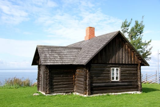 The wooden house close up and the blue sky