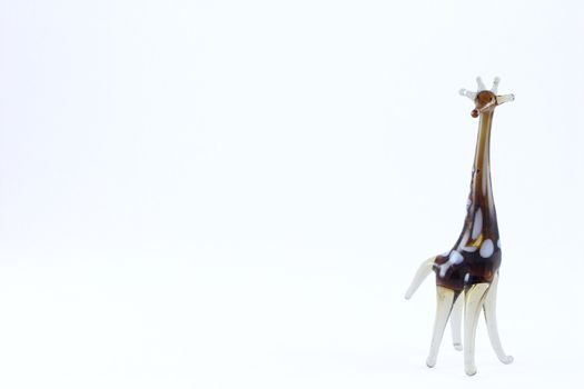 Glass toy a giraffe removed on a white background close up