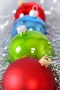 Four fur-tree toys in a tinsel removed close up