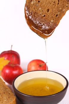 Bread, honey and apples removed close up on a linen napkin