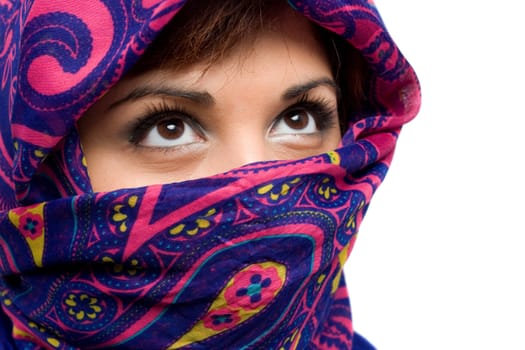 An attractive woman wearing a traditional head covering.