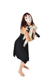 a redhead in a strange mask playing with a doll set on a white background