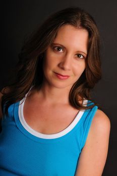 attractive young woman posing on a dark background