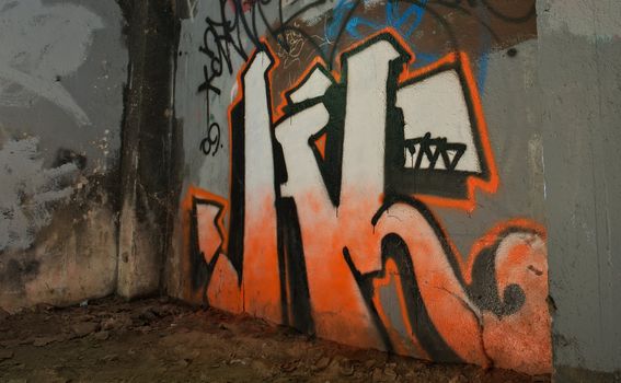 Graffiti painted on a concrete wall in an abandoned building.