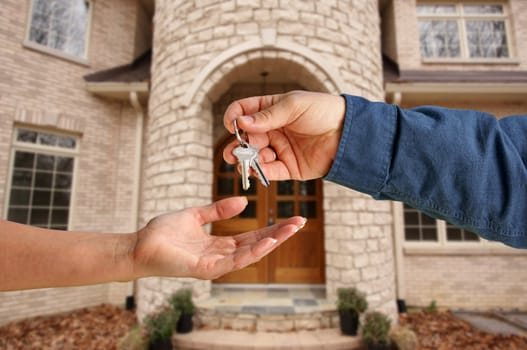 Handing Over the House Keys in Front of a Beautiful New Home.