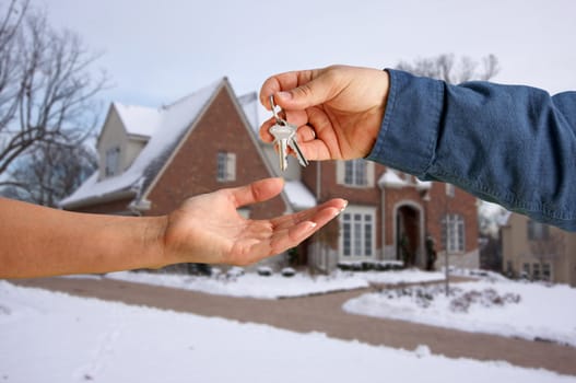 Handing Over the House Keys in Front of a Beautiful New Home.