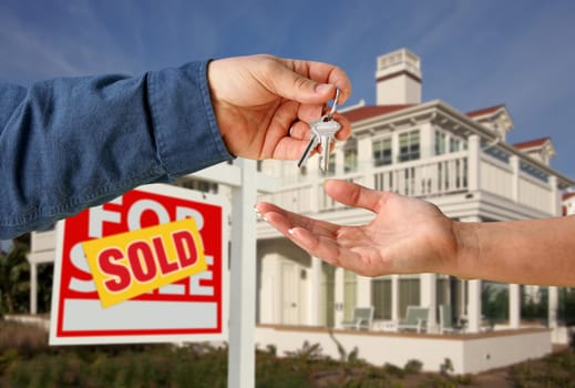 Handing Over the House Keys in Front of a Beautiful New Home.