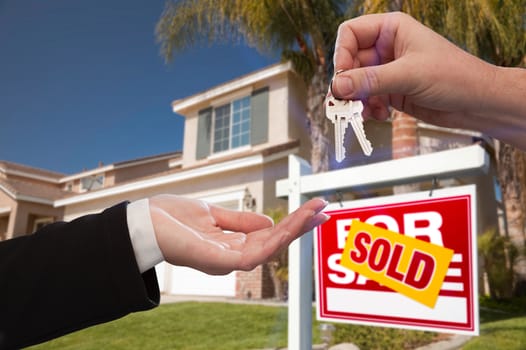 Handing Over the House Keys in Front of a Beautiful New Home.