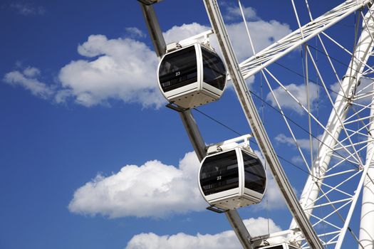 A couple of ferris wheel cars against a beautiful blue sky