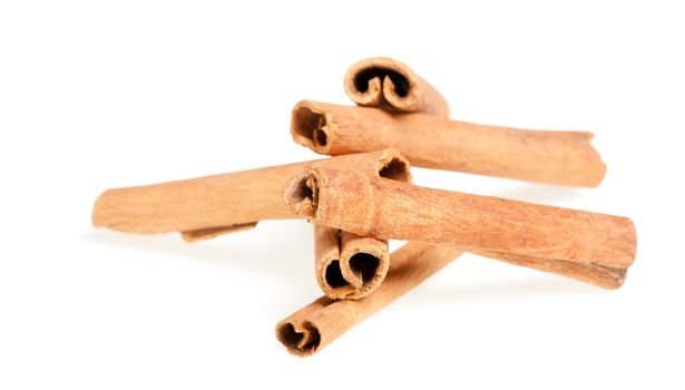 Cinnamon. A heap of sticks of cinnamon on a white background