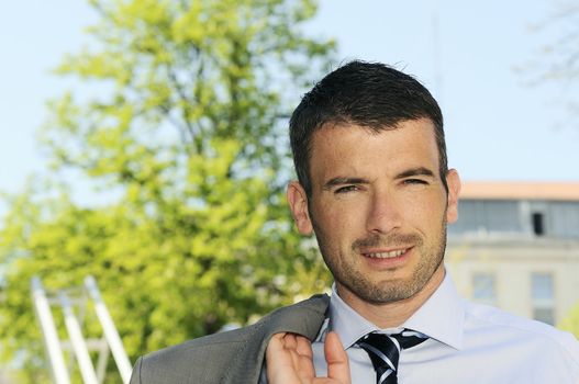 An attractive business man is walking outdoor