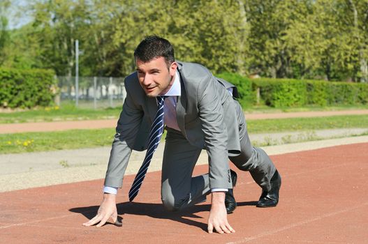 Portrait of a businessman on the starting blocks