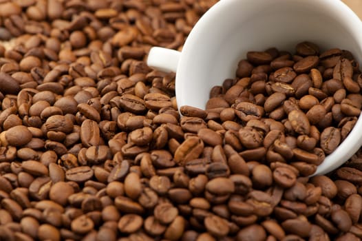 White cup with coffee grains. A photo close up