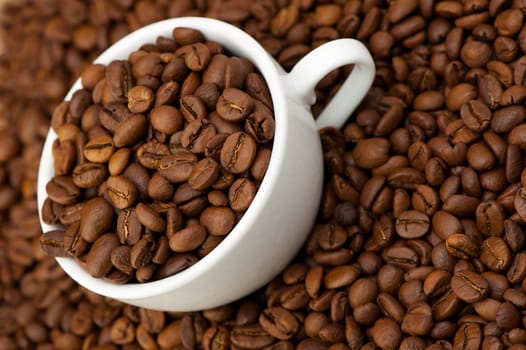 White cup with coffee grains. A photo close up