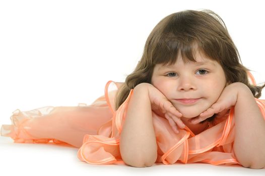 Pretty the little girl lies on the white. It is isolated on a white background