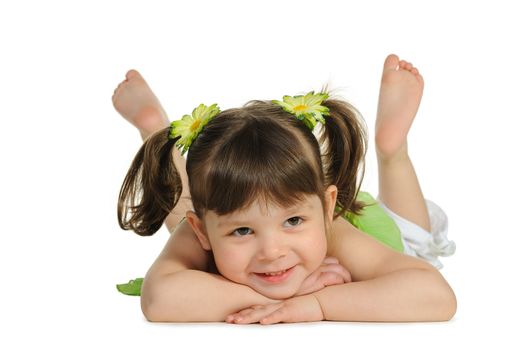 Pretty the little girl lies on the white. It is isolated on a white background