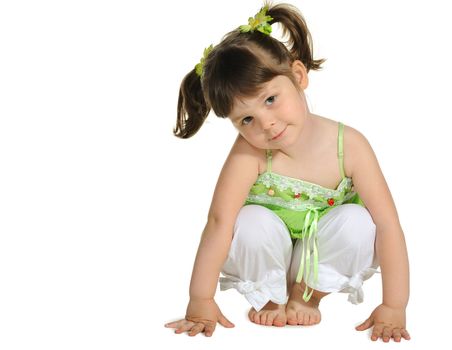 Pretty the little girl sits on the white. It is isolated on a white background