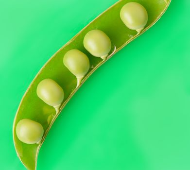 Pea. A photo by close up of green peas it is isolated on a green background