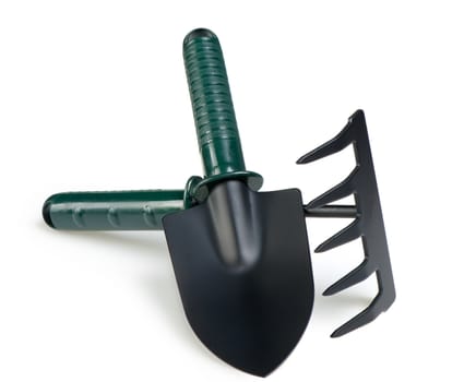 The garden tool a shovel, a rake. Isolated on a white background