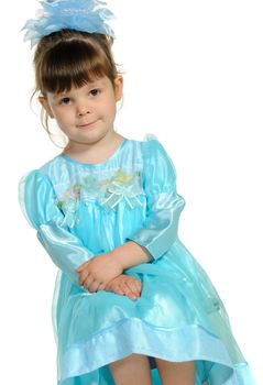 Pretty the little girl in a blue dress. It is isolated on a white background