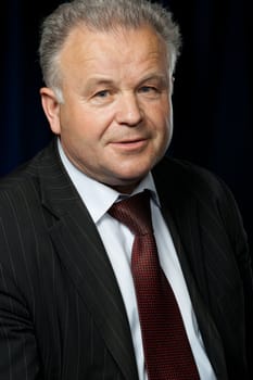 Portrait of the elderly man. A photo against a dark background