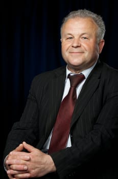 Portrait of the elderly man. A photo against a dark background