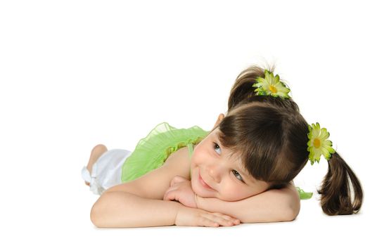 Pretty the little girl lies on the white. It is isolated on a white background