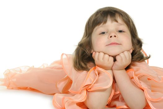 Pretty the little girl lies on the white. It is isolated on a white background