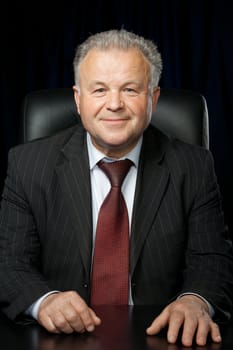 Portrait of the elderly man. A photo against a dark background