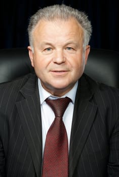 Portrait of the elderly man. A photo against a dark background