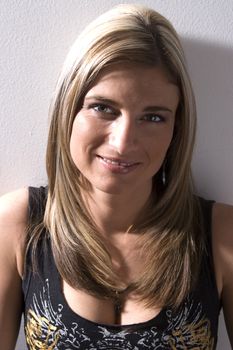 Portrait of a thirty something women leaning wall with rocker style