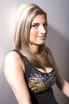 Portrait of a thirty something women leaning wall with rocker style
