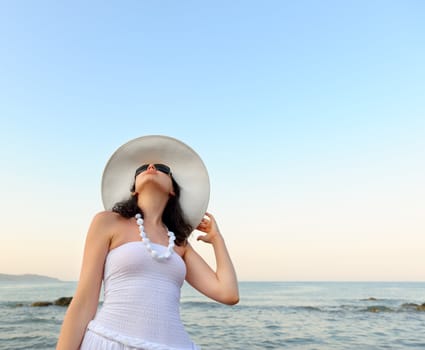 Portrait of the young woman in a hat. Seacoast