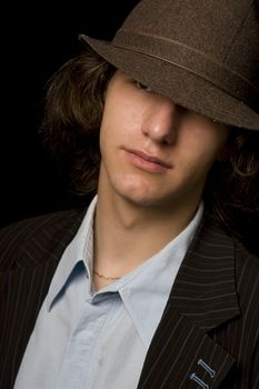 Male teenager wearing a suit and hat