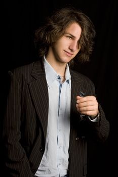 Male teen wearing a casual suit with strain of hair in front of his eyes