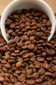 White cup with coffee grains. A photo close up