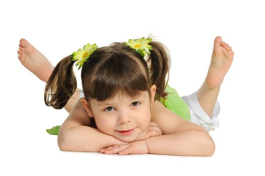 Pretty the little girl lies on the white. It is isolated on a white background